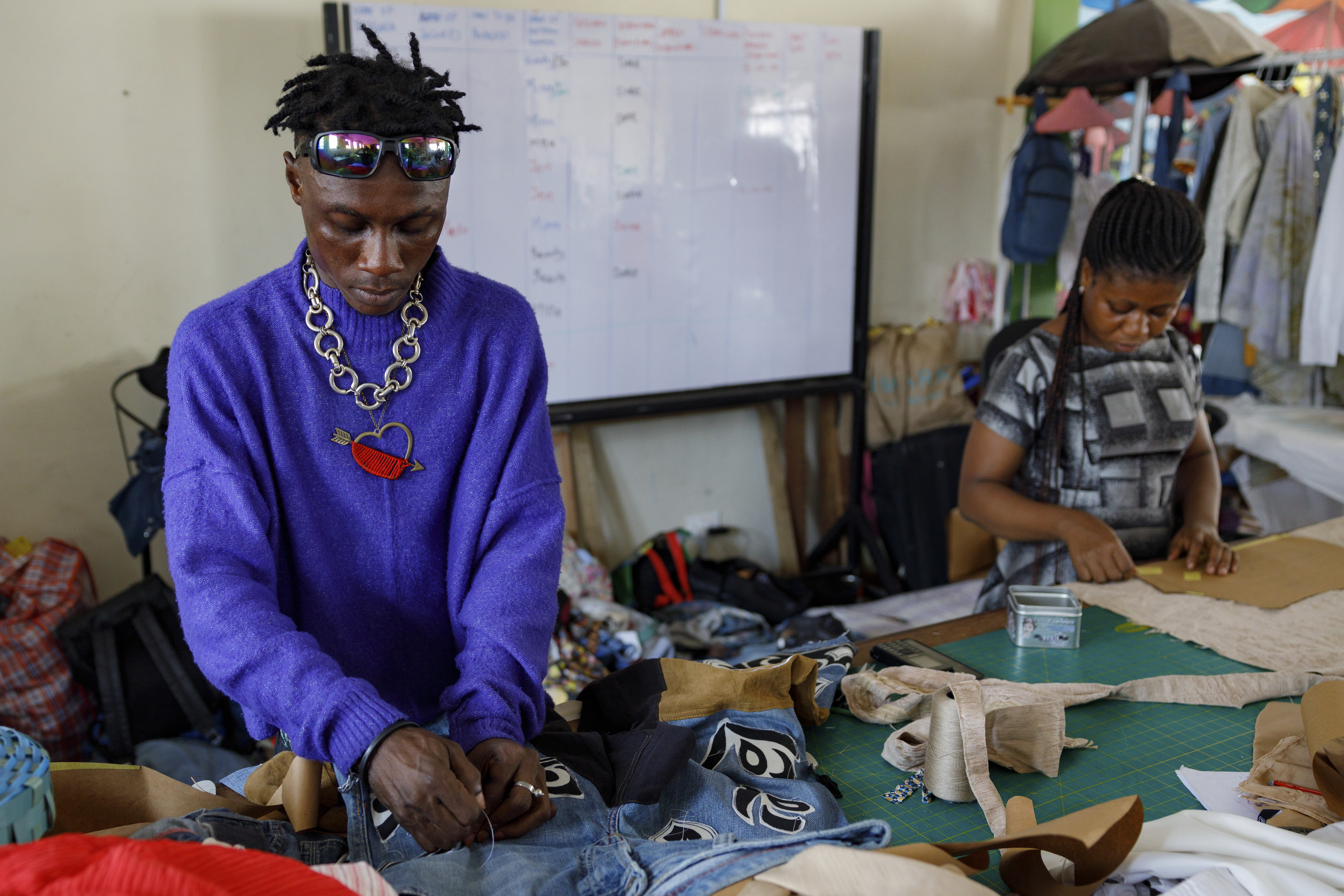 Designers work in the remanufacturing space at the OR Foundation to upcycle textile waste in Accra, Ghana, Thursday, Oct. 24, 2024. (AP Photo/Misper Apawu)