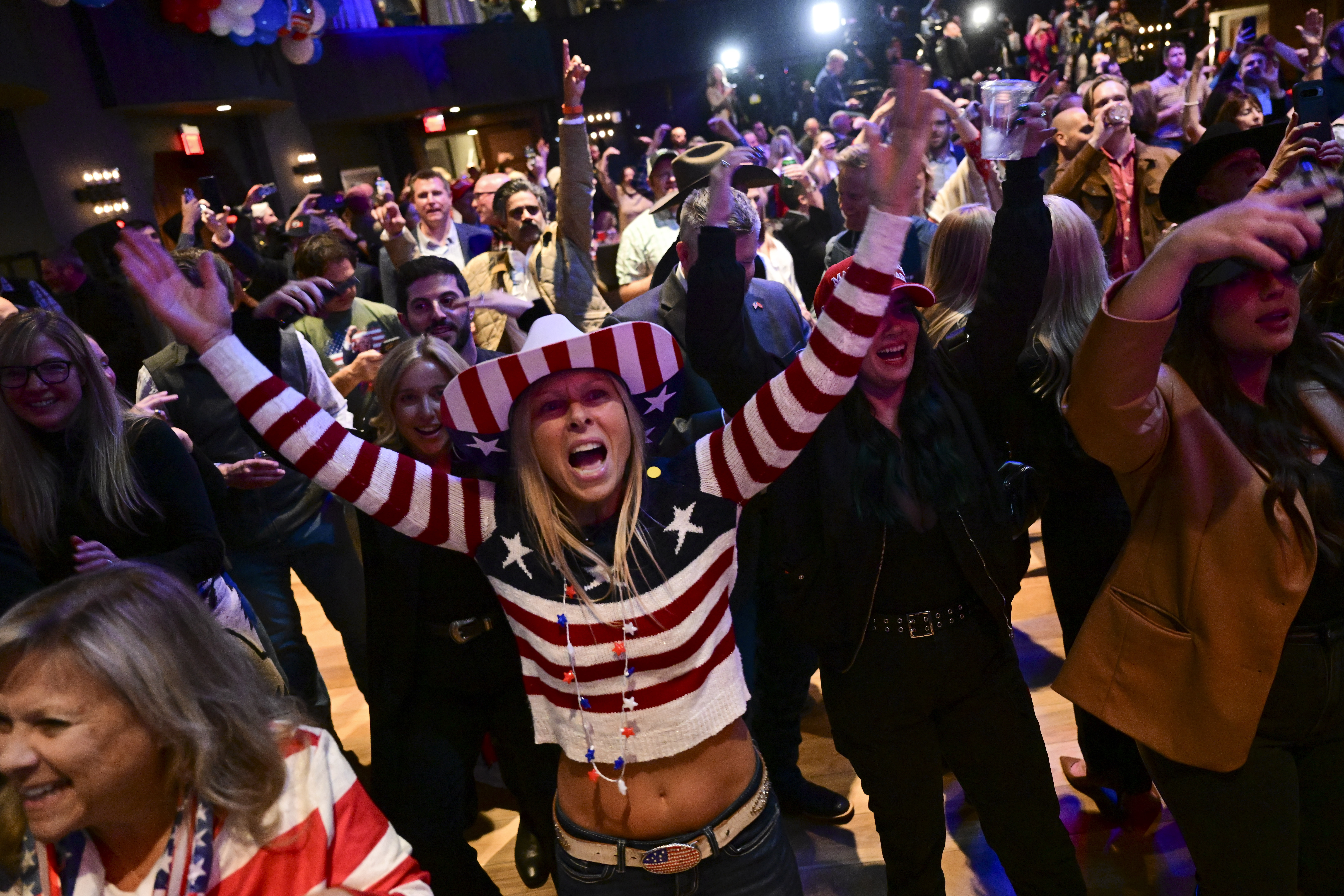 FILE - Supporters cheer at an election night watch party for Republican Montana Senate candidate Tim Sheehy, Nov. 6, 2024, in Bozeman, Mont. (AP Photo/Tommy Martino, File)